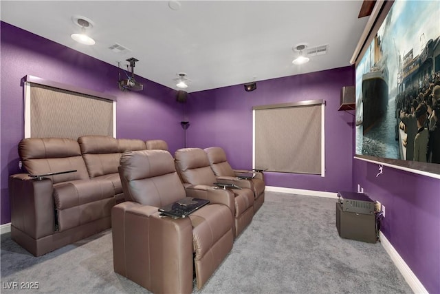 cinema room featuring light colored carpet