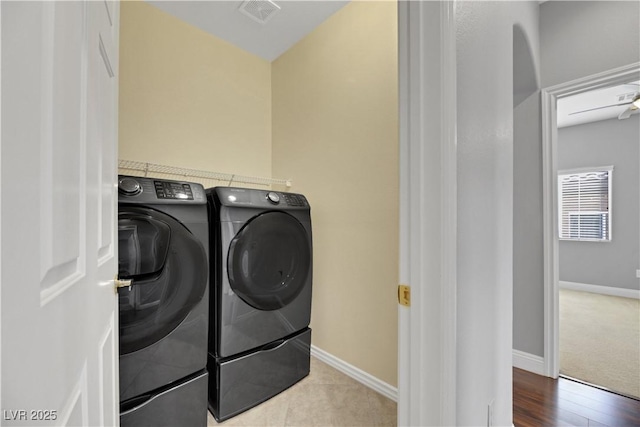 clothes washing area featuring tile patterned floors and washing machine and clothes dryer