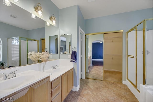 bathroom with tile patterned floors, vanity, and a shower with shower door