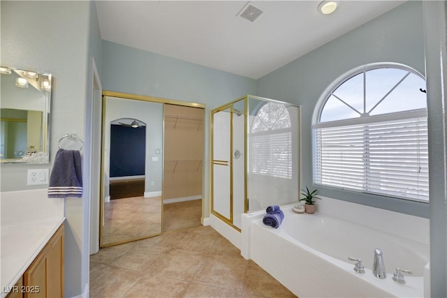 bathroom featuring tile patterned flooring, vanity, and independent shower and bath