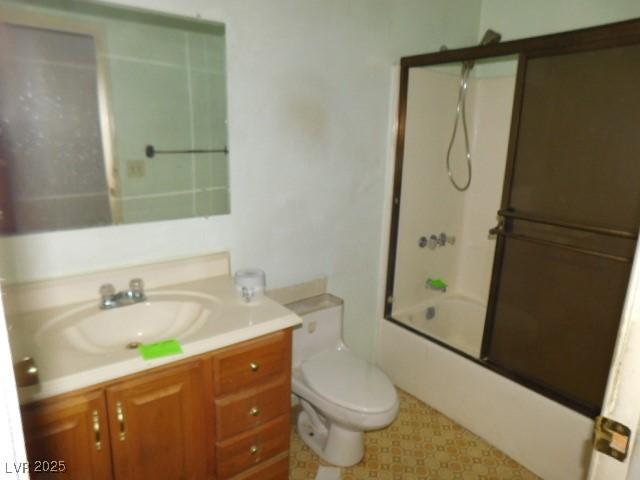 full bath featuring enclosed tub / shower combo, vanity, and toilet