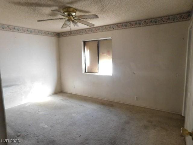 unfurnished room featuring light carpet, ceiling fan, and a textured ceiling