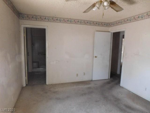 spare room with a ceiling fan and a textured ceiling