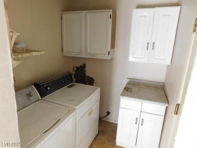 washroom featuring washing machine and dryer and cabinet space