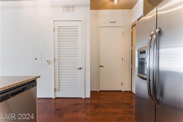 kitchen featuring dark wood-type flooring and appliances with stainless steel finishes