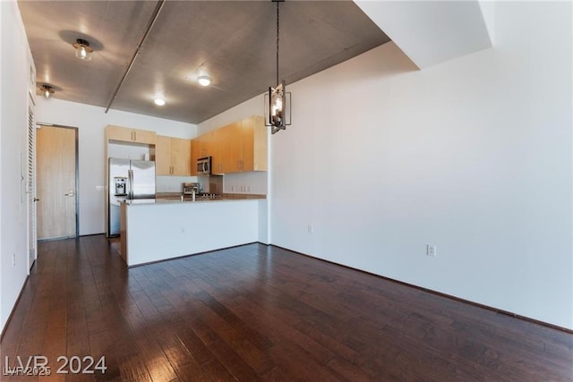 kitchen featuring dark hardwood / wood-style floors, kitchen peninsula, decorative light fixtures, light brown cabinetry, and appliances with stainless steel finishes