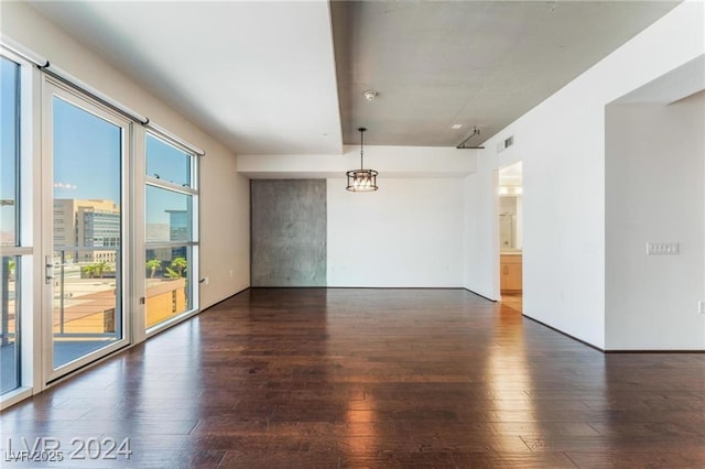 spare room featuring dark wood-type flooring