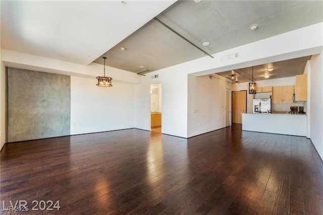 unfurnished living room featuring dark hardwood / wood-style floors