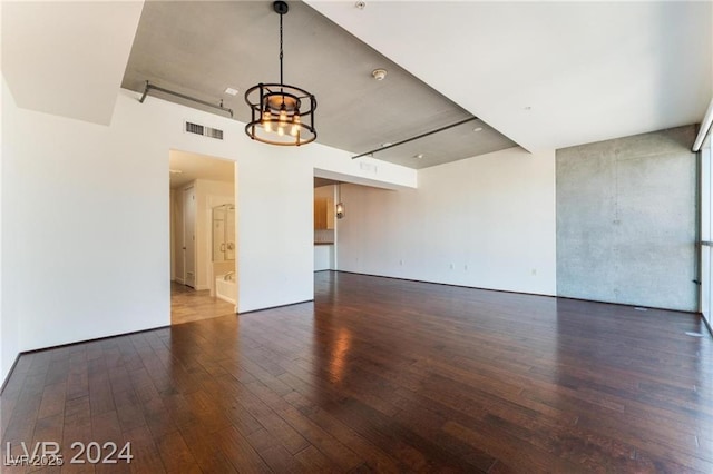 interior space with a chandelier and dark hardwood / wood-style floors