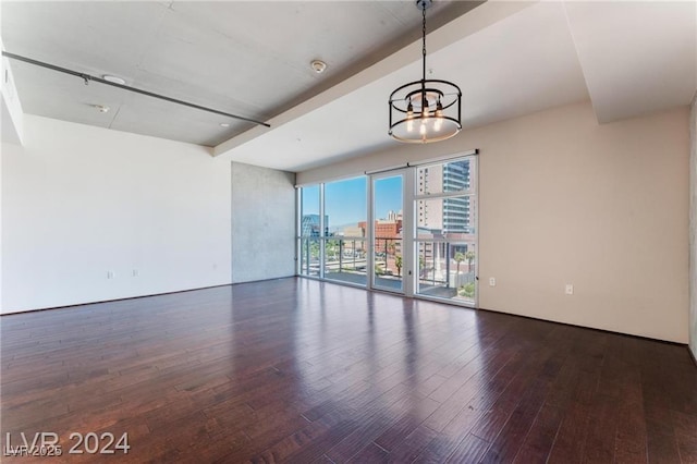 interior space with a chandelier, beamed ceiling, and dark wood-type flooring