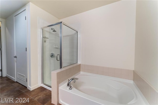 bathroom featuring tile patterned floors and independent shower and bath