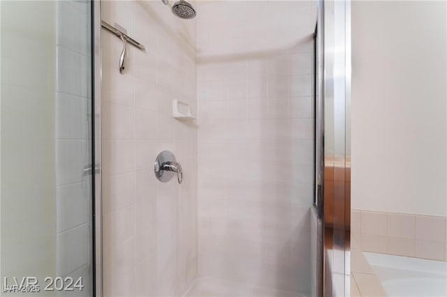 bathroom with a shower with door