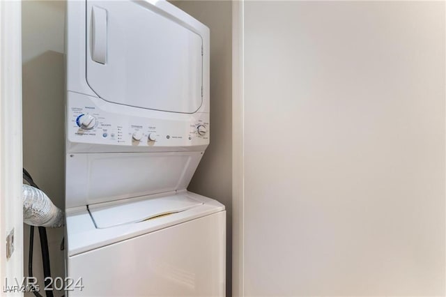 laundry room featuring stacked washer / drying machine