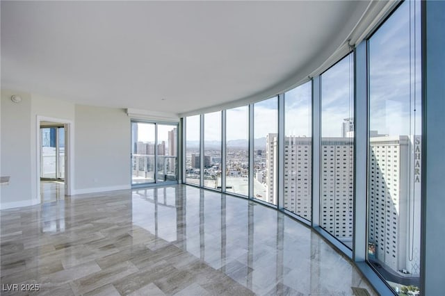 unfurnished room featuring floor to ceiling windows