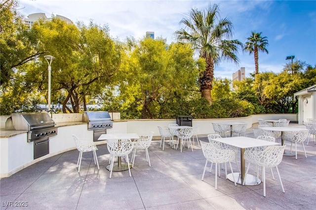 view of patio featuring an outdoor kitchen and a grill