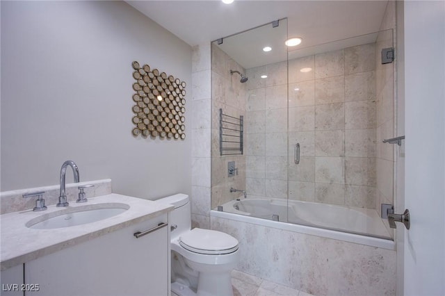 full bathroom with combined bath / shower with glass door, vanity, and toilet