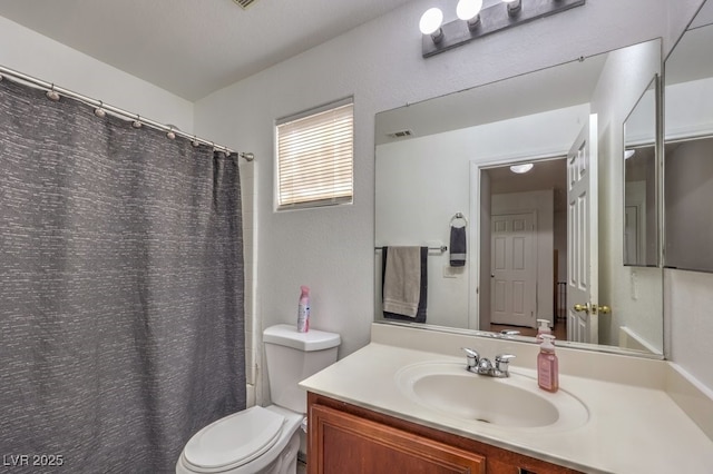 full bathroom featuring vanity, shower / bath combination with curtain, and toilet