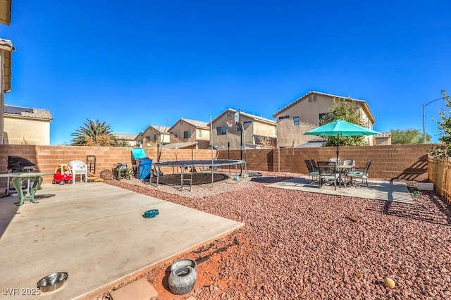 view of yard featuring a patio and a trampoline