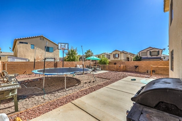 exterior space featuring a trampoline and a patio area