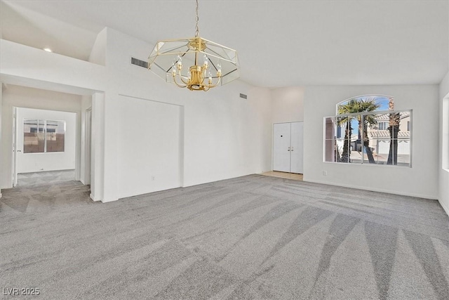 empty room featuring a notable chandelier, carpet floors, and high vaulted ceiling