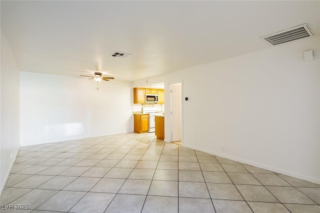 unfurnished living room with light tile patterned floors and ceiling fan