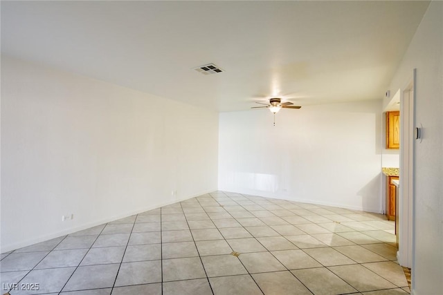 spare room with light tile patterned floors and ceiling fan