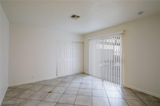 spare room featuring light tile patterned floors