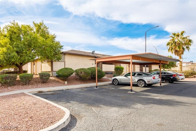 view of parking / parking lot featuring a carport