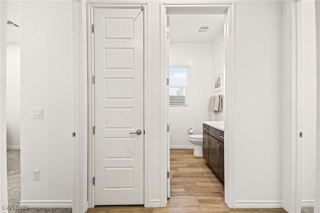 bathroom featuring hardwood / wood-style floors, vanity, and toilet