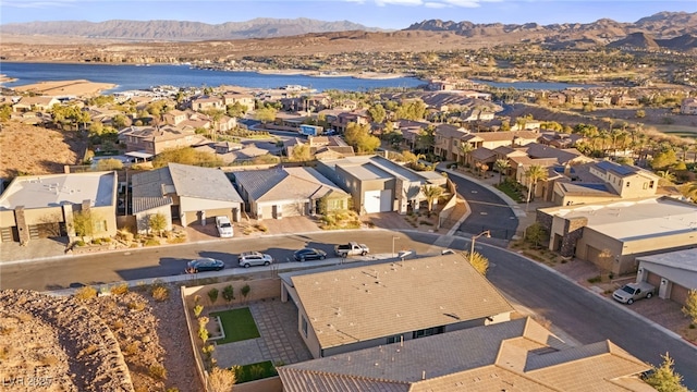 drone / aerial view featuring a water and mountain view