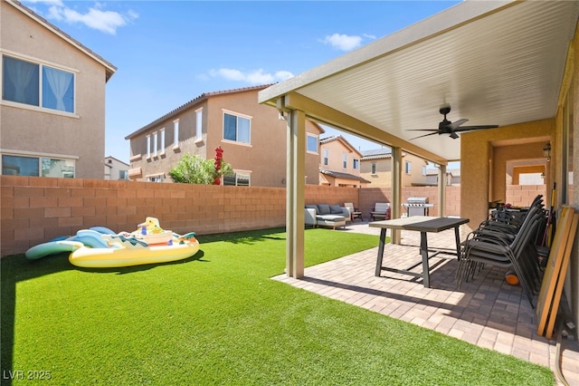 view of yard with outdoor lounge area, a patio, a ceiling fan, and a fenced backyard