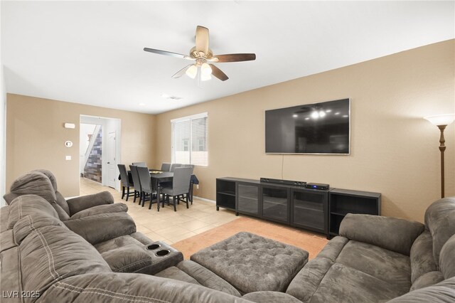 tiled living room featuring ceiling fan