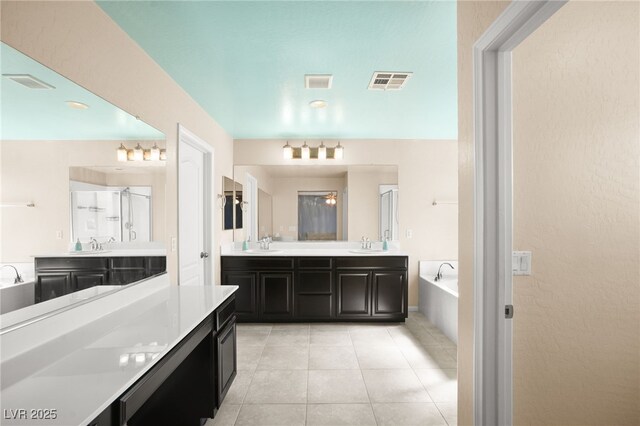 bathroom featuring tile patterned floors, vanity, and independent shower and bath