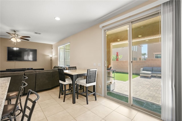 dining area with light tile patterned floors, visible vents, a healthy amount of sunlight, and a ceiling fan