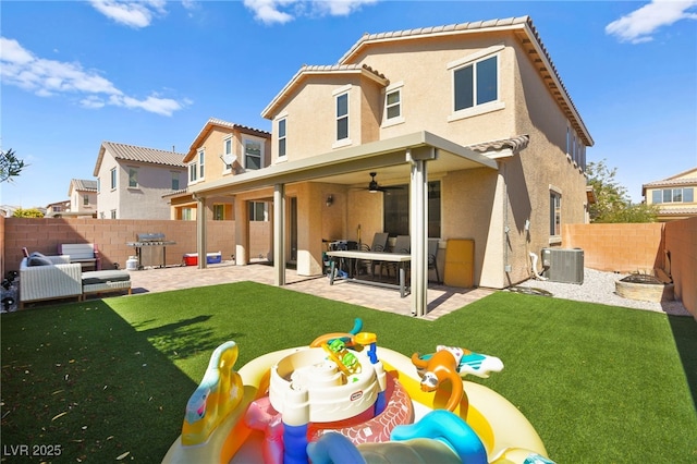 back of property featuring central AC unit, stucco siding, a yard, a fenced backyard, and a patio area