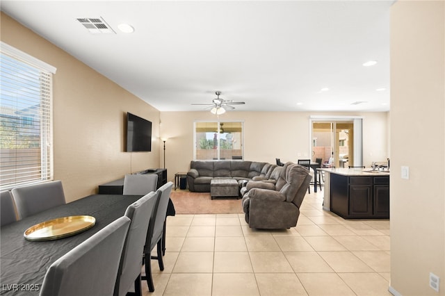 living area featuring light tile patterned floors, visible vents, recessed lighting, and a ceiling fan