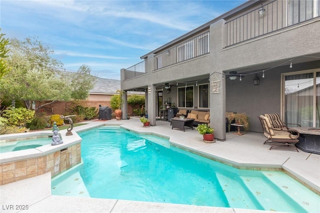 view of swimming pool with an in ground hot tub, a patio, and an outdoor hangout area