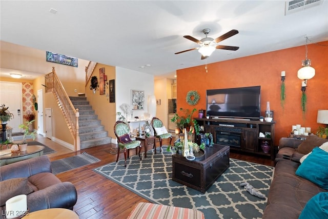 living room with hardwood / wood-style floors and ceiling fan