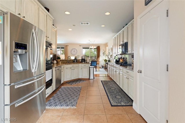 kitchen featuring sink, stainless steel appliances, backsplash, kitchen peninsula, and light tile patterned flooring