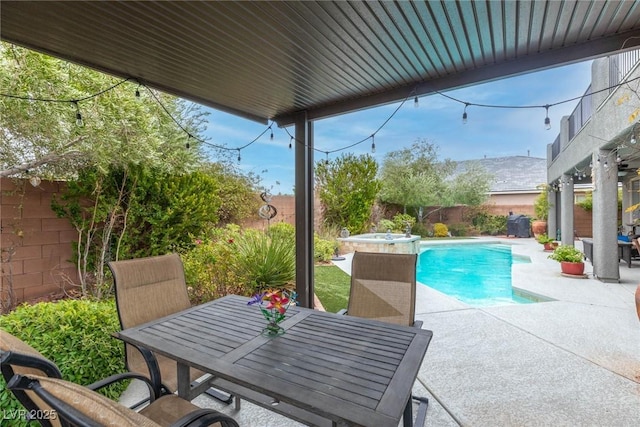 view of swimming pool featuring a patio and a hot tub