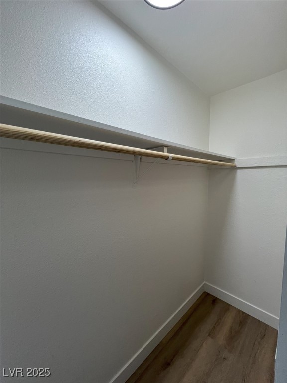 walk in closet featuring dark hardwood / wood-style flooring