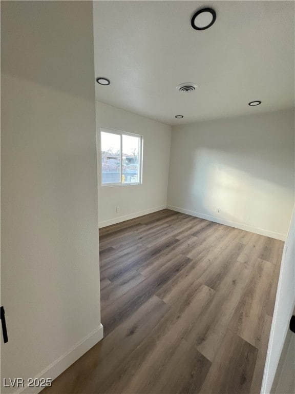 empty room featuring hardwood / wood-style flooring