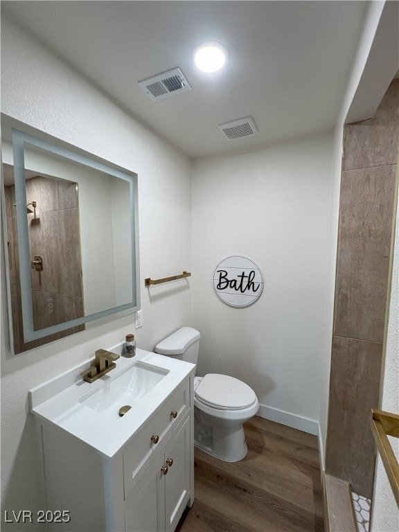 bathroom featuring hardwood / wood-style floors, vanity, and toilet