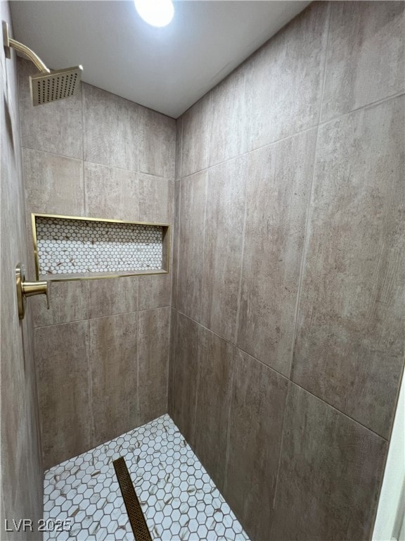 bathroom with a tile shower