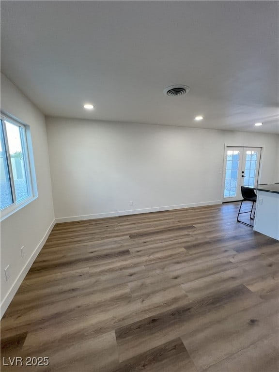 spare room featuring dark wood-type flooring and french doors