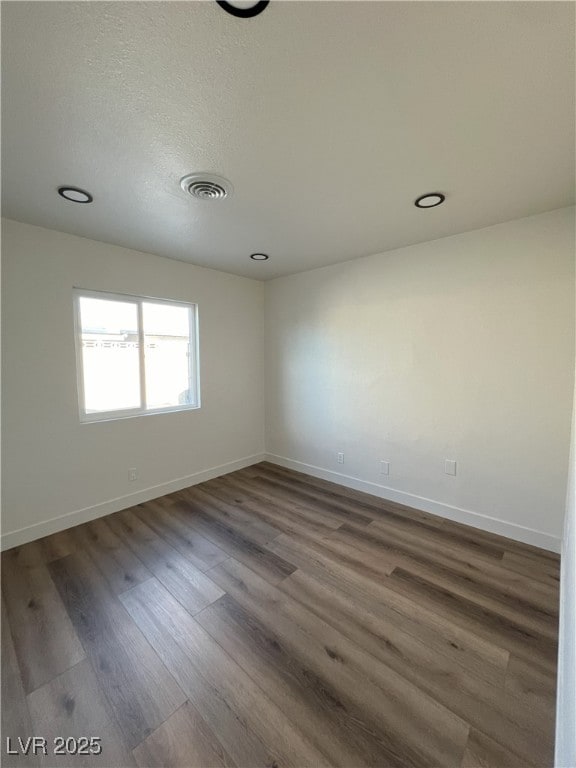 empty room featuring dark hardwood / wood-style flooring