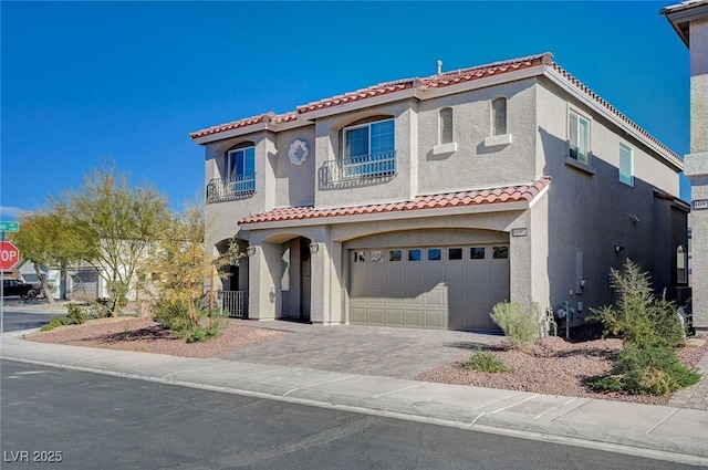 mediterranean / spanish-style home with a garage