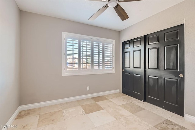 unfurnished bedroom with ceiling fan and a closet