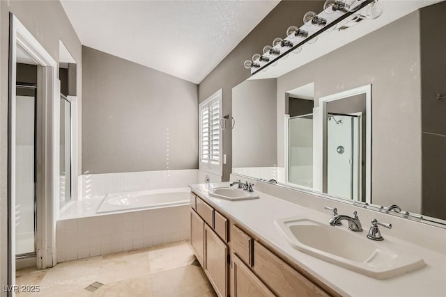 bathroom featuring tile patterned floors, a textured ceiling, vanity, vaulted ceiling, and separate shower and tub