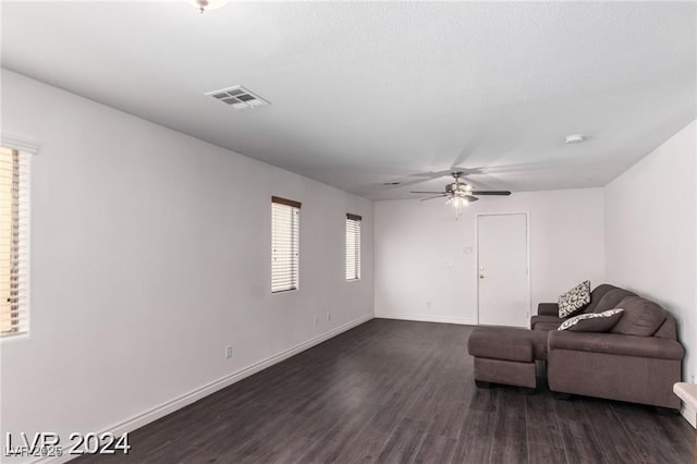 living room with ceiling fan, a healthy amount of sunlight, and dark hardwood / wood-style floors